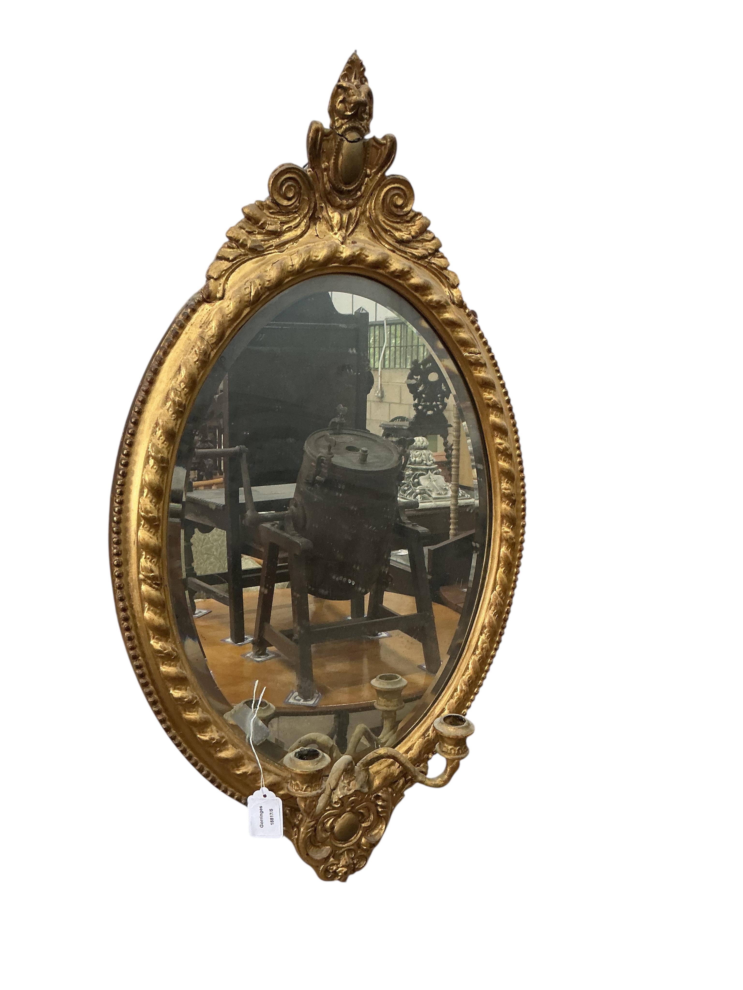 A Victorian oval giltwood and composition girandole wall mirror, width 49cm, height 87cm